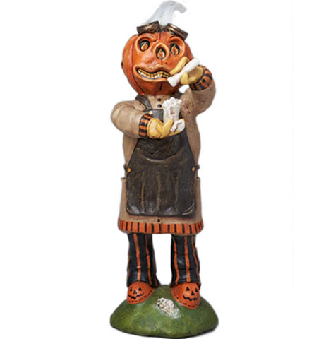 the mad pharmacist figurine is wearing a pumpkin for a head with flight googles on top of his head. he is pour liquid into a beaker, with a metal apron and Pumpkin slippers