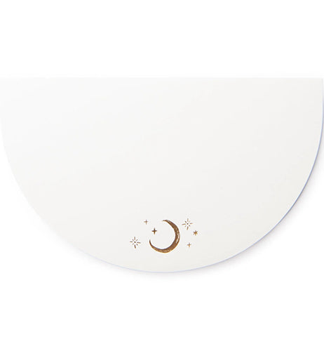 A white half-circular notepad with a half-moon and star design is barely visible against a white background.