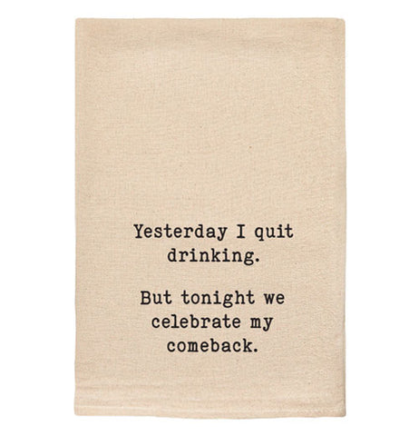 A beige tea towel with black text reading "Yesterday I quit drinking. But tonight we celebrate my comeback."