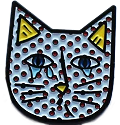 An abstract cry cat pin. the background of the cat pin is white with red spots it has yellow triangles to represent the inside of its ears and a yellow nose.