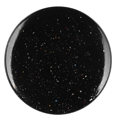 This black salad plate teems with white paint splattered polka dots.