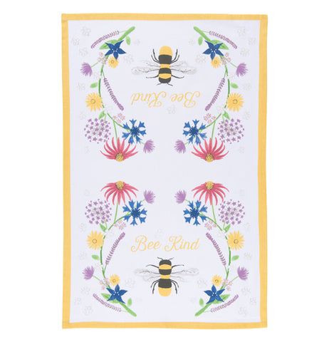 This white tea towel with a yellow rim surrounding its edges sports a design of bees and red, purple, yellow, and blue flowers and yellow text that reads "Bee Kind".