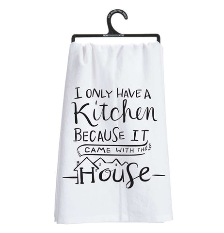 This white dish towel on a hanger contains black text saying, "I Only Have a Kitchen Because it Came With the House".