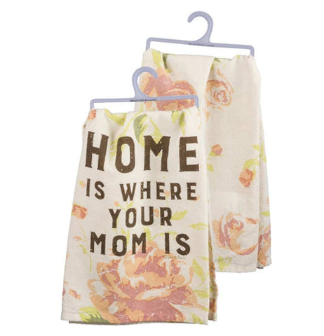 A front and back view of a faded floral print towel. The front reads "Home is Where Your Mom Is" and the back has the faded floral print of roses on a white background.