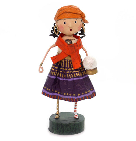 This figurine is of a girl in a fortune teller costume with gold, purple, and red dress, holding a crystal ball.