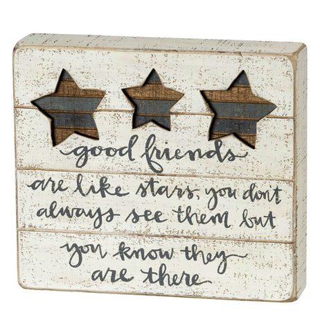 This cream colored wooden box sign has three stars stenciled in at the top, and beneath the stars are the stenciled gray words, "Good friends are like stars. You don't always see them, but you know they are there."