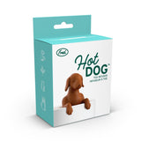 "Hot Dog" tea infuser box wth image of top of dog shaped infuser in a white mug with green words that read "Hot Dog" over a white background.