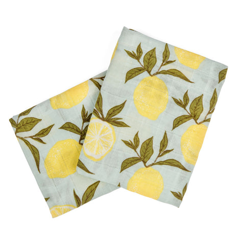 Two turquoise baby burp cloths with yellow lemons hanging from green leaves are shown from two different sides.