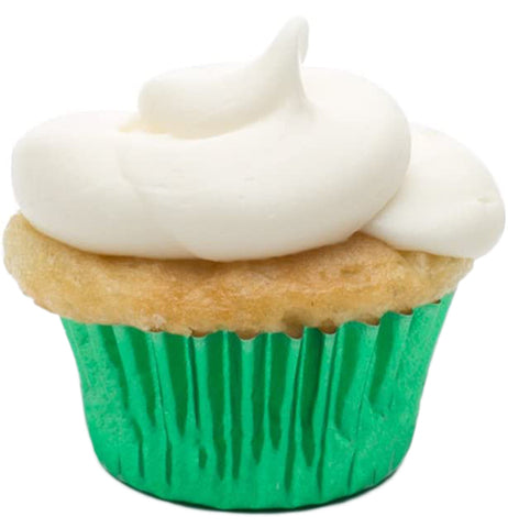 A green, shiny muffin cup is shown right side up and with a cupcake with white cream inside of it.
