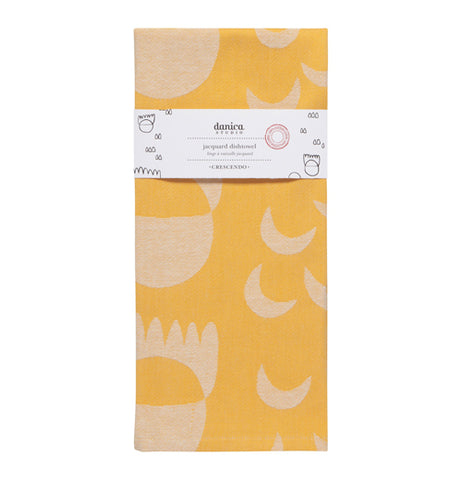 "Crecsendo" jacquard yellow tea towel with white shape design folded up with a white wrapper band on it.