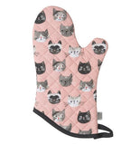 This pink oven mitt with a black outline shows different cat faces, which include white, grey, black, and black and white cats.