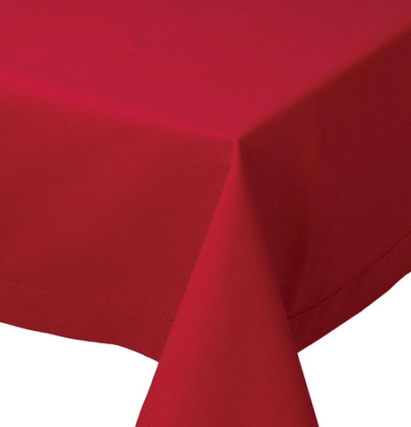 Close up of a table's corner that is covered with the red "chili" hemstitched tablecloth.