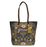 Black bucket tote featuring a gold fern and pink flower design that says "Grow" in pink with brown handles and gold tassel.