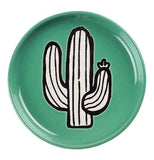 Round green coaster with black and white cactus design on a white background.