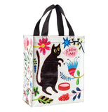 This Handy Tote "Chow Time" bag has a design of a black cat with a speech bubble that reads "Chow Time" along with floral designs scattered all over the white bag.