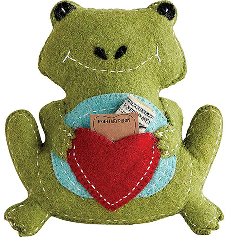 A green felt frog has a blue circle and red heart in the middle. A piece of paper with the words "tooth fairy pillow" and a dollar bill stick out.