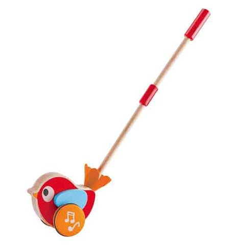 A wooden bird toy has a push handle that a baby can use. The toy is tan, orange, and red. It faces the left edge.