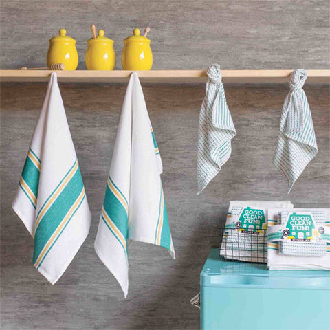 The teal set of 4 dishtowels (two big ones that are white with teal large and small stripes along the top and bottom, and two small ones that are white with dashed stripes) hanging up that displays what it looks like to have them in your home.
