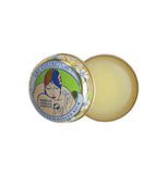 A circular gold, white, and brown art neaveau tin has beige lip balm in it.