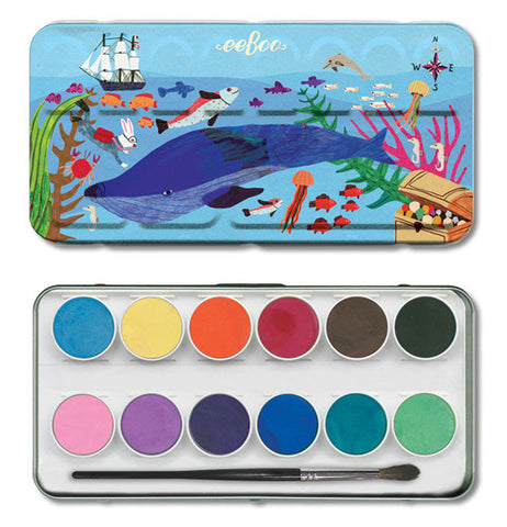 The cover to the water color case sits above the bottom the different colors in the kit.