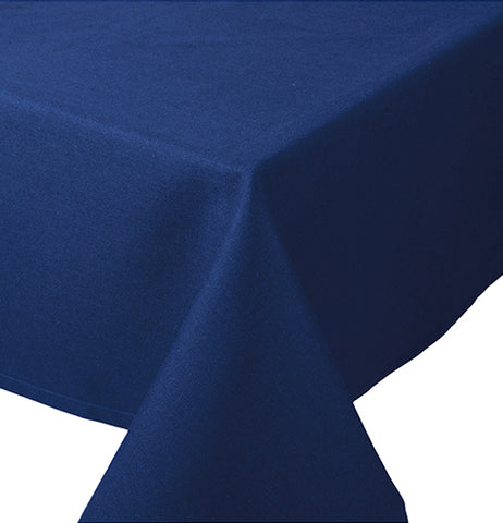 The Rectangle "Spectrum" Tablecloth is Indigo-colored and folded at the end of the table.