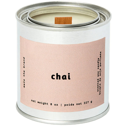 A gray tin candle-shaped can with a pastel brown label. The label says "Mala the brand--cottage--Net weight 8 oz. -- scented soy candle." There is also French text, but this alt text writer is woefully monolingual.