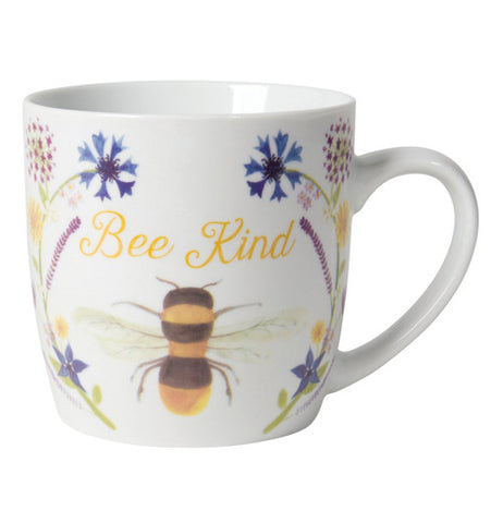 The white mug says "Bee Kind." The cup has a large bubble bee and 2 blue flowers.