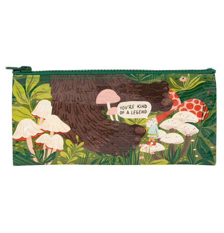 A pencil case with a gnome standing next to a pair big foot feet with mushrooms and plants all around and a word balloon that says "You're KIND of a Legend"