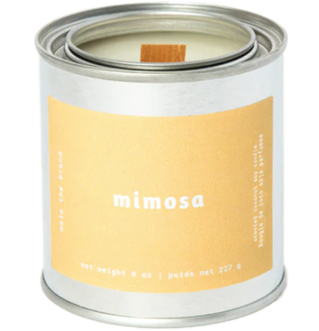 A gray tin candle-shaped can with a pastel orange label. The label says "Mala the brand--mimosa--Net weight 8 oz. -- scented soy candle." There is also French text, but this alt text writer is woefully monolingual.