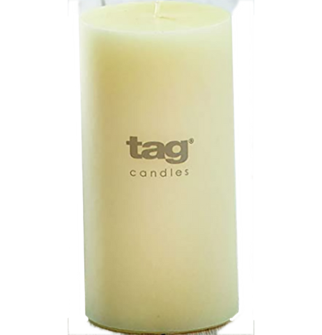 An ivory/off-white candle. Text on it say "Tag Candles."