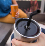 A metal reusable straw is shown being in the hole in the drink lid.
