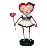 Female figurine with heart shaped head holding a heart shaped wand with "sweetheart" printed on it 