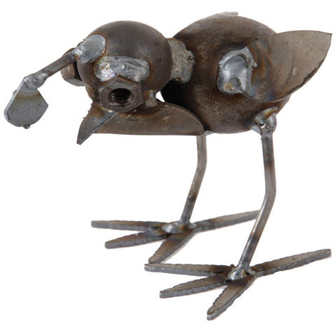 This metal baby quail sculpture head is shown looking down for worms to eat.
