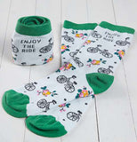 Two pairs of bike print hobby socks ,one pair laid open flat for display, one pair folded which say "Enjoy the ride".
