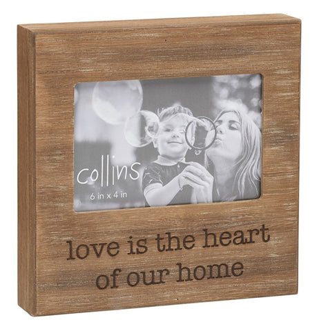 The "Love is Heart" Photo Frame features a message that says, "Love is the Heart of Our Home" burned in black over a natural wood background. 