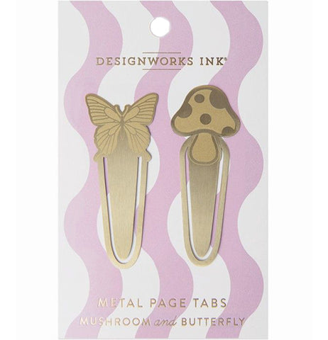 Two metal page tabs are packaged for sale. The page tabs have a butterfly and mushroom design. The package has a pink and white wavy design and reads "DesignWorks Ink - metal page tabs - mushroom and butterfly."