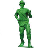 A green plastic army man toy holding a walkie-talkie.