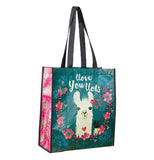 Blue and pink gift bag over a white background with design of a white llama and words that say Love You Lots surrounded by pink flowers.