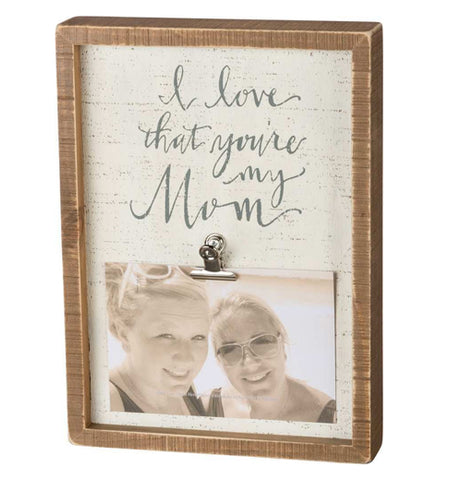 The Inset "My Mom" Box Frame has text that reads, "I Love That You're My Mom" in a cursive script at the top with a photo attached to a clip at the bottome. 
