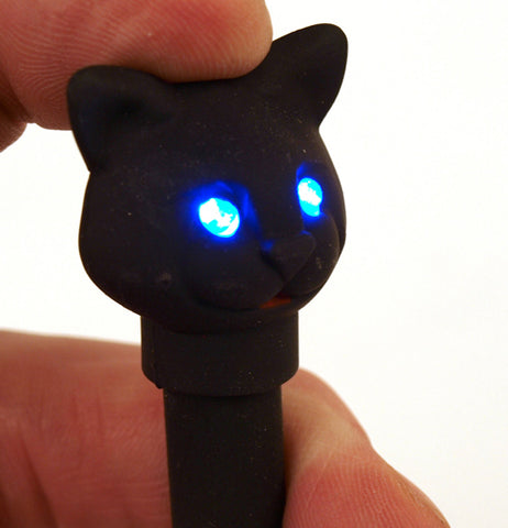 Black LED cat pen with the eyeys of the cat head lit up.
