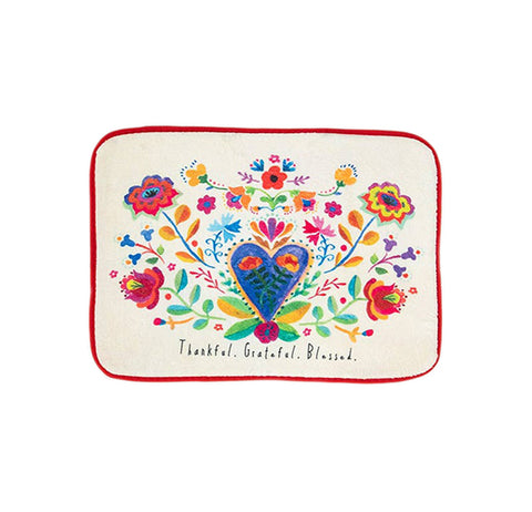 This drying mat with red edges has a floral design of red and yellow flowers and a blue heart shaped plant in the middle. Below the floral design are the words, "Thankful, Grateful, Blessed" in black lettering.