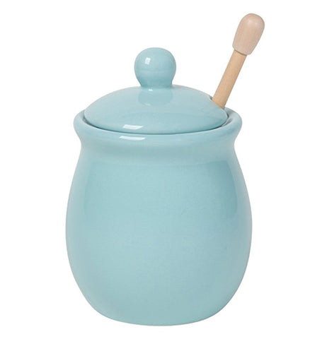 Baby blue honey pot with lid and honey dipper inside.