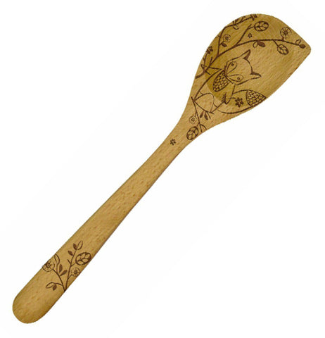 A wooden spoon with an etched image of a fox Standing Next to a Flower on a Tree Branch.