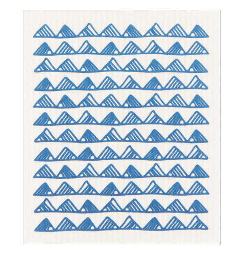 A dishcloth with blue mountain designs.