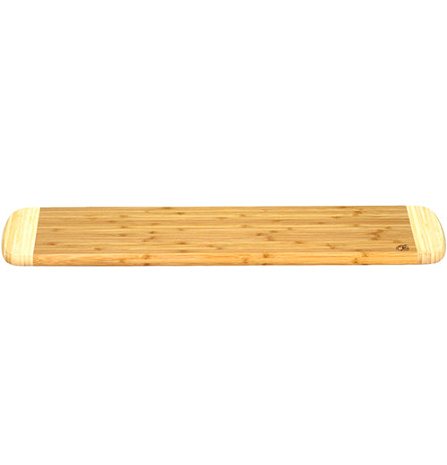 A long wooden cutting board from a side angle.
