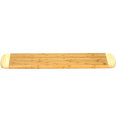 A long wooden cutting board from a side angle.