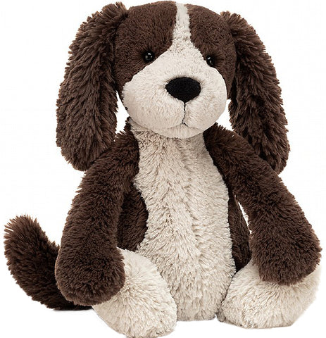 this is a floppy earred brown and white stuffed dog. black eyes and nose.