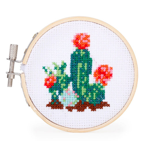 Embroidered cactus in bloom on a small hoop held shut by a metal bolt.
