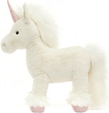 A creamy white unicorn with pink hooves and horn stands with the side facing you.