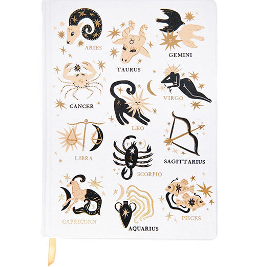 A white journal with black, gold, and yellow astrology designs on it.